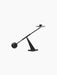 A sculptural Moment Candlestick Holder in black, from an angle, featuring a balancing arm with a spherical counterweight.