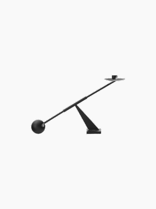 Side view of a modern minimalist black candle holder with a balancing arm, spherical counterweight, and single candle socket.