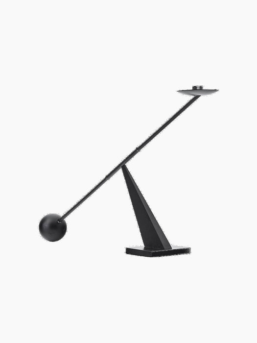 Interconnect Candle Holder, a sculptural piece with a geometric base and a long, balancing rod with a spherical weight.