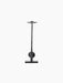 Rear view of the sculptural black Interconnect Candle Holder. It has a flat base, a stem through a sphere, and a top disc.