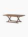Jäger Lounge Table in oiled walnut shown at an angle, with a rectangular top and foldable X-shaped base with brass fittings.