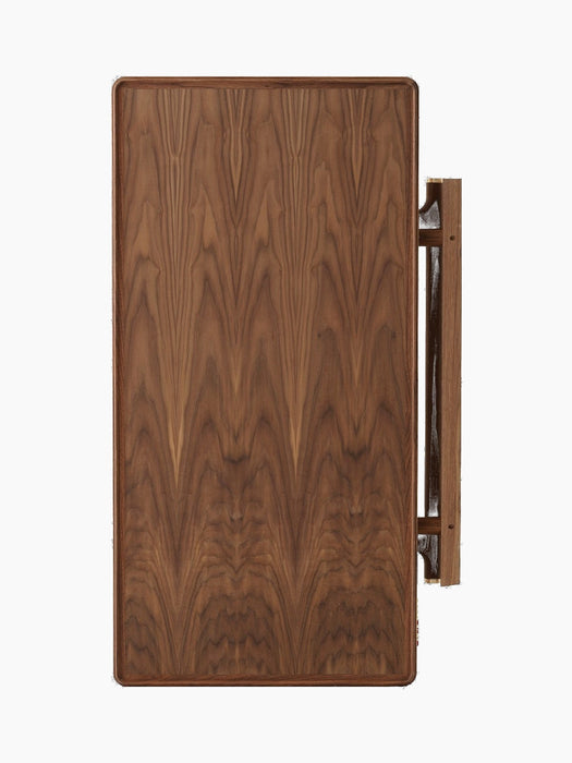 A front view of the foldable Jäger Lounge Table in walnut. The table is folded, highlighting the rich grain of the wood.