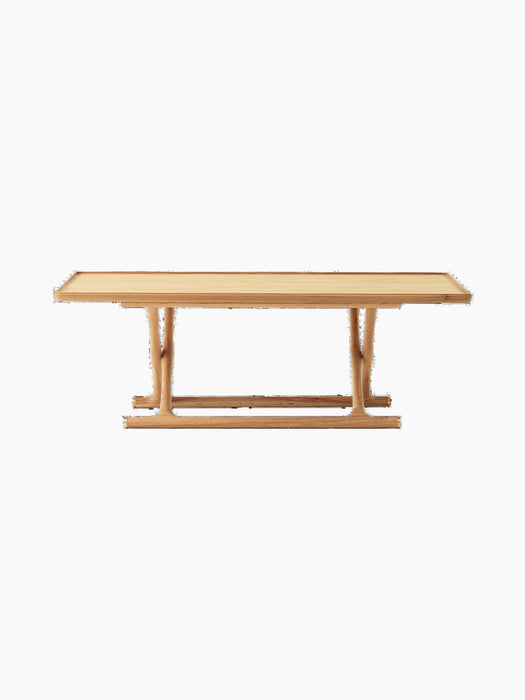 Front view of the Jäger Lounge Table in Natural Oak, featuring a long rectangular top and distinctive foldable legs.