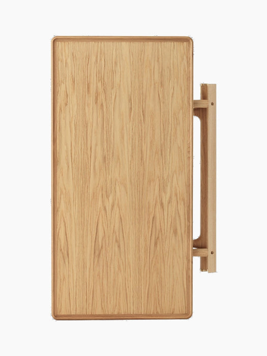A top-down view of the foldable Jäger Lounge Table in natural oak, pictured in its folded state against a black background.