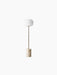 Front view of the JWDA Floor Lamp, featuring a travertine base, a slender brushed brass stem, and a white opal glass shade.