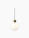 JWDA Metallic Pendant Lamp in polished brass with a white opal glass globe and a black dimmer switch on a black background