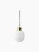 A JWDA Metallic Pendant Lamp with a polished brass fitting and an opaque white glass shade hanging from a black cord.