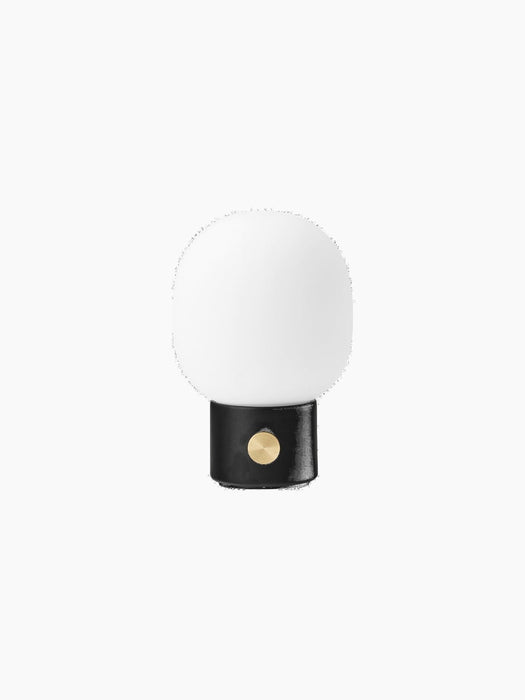 Front view of the JWDA Table Lamp, Portable in black. It has a cylindrical base, brass dimmer, and frosted white shade.
