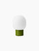 Rear view of the dusty green JWDA Table Lamp, Portable, showing its cylindrical steel base and elliptical white glass shade.