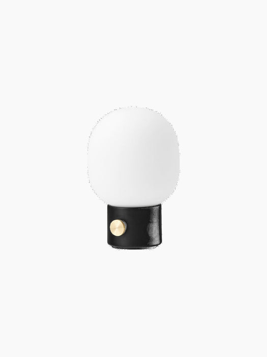Angled view of the JWDA Table Lamp, Portable, with a black base, round brass dimmer switch and white glass shade.