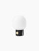 Angled view of the JWDA Table Lamp, Portable, with a black base, round brass dimmer switch and white glass shade.