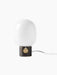 A front view of the JWDA Table Lamp, Small, with a bronzed brass base, a brass dimmer, and a large white opal glass shade.