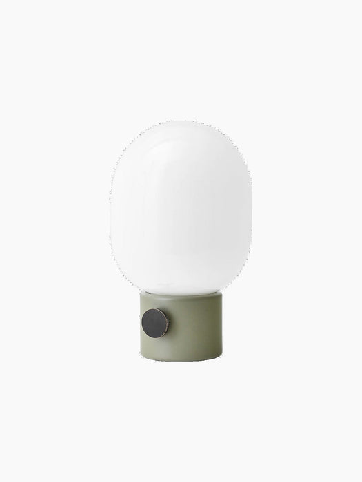 Angled view of the JWDA Table Lamp, Small, featuring an ammonite grey base with a brass dimmer and a white opal glass shade.
