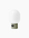 Angled view of the JWDA Table Lamp, Small, featuring an ammonite grey base with a brass dimmer and a white opal glass shade.