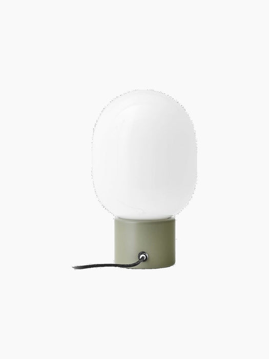 Rear view of the JWDA Table Lamp, Small in Ammonite Grey, with a white opal glass shade and black cord.