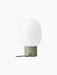 Rear view of the JWDA Table Lamp, Small in Ammonite Grey, with a white opal glass shade and black cord.