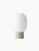 Front view of the JWDA Table Lamp in light grey concrete, with a brass dimmer knob and a rounded white opal glass shade.
