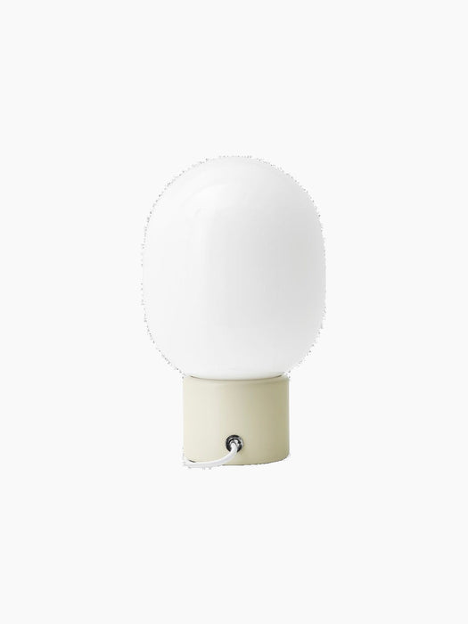 Back view of the JWDA Table Lamp, Small, with an alabaster white steel base and a white opal glass shade.