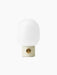 Front view of the JWDA Table Lamp, Small, with an Alabaster White steel base, brass dimmer and white opal glass shade.