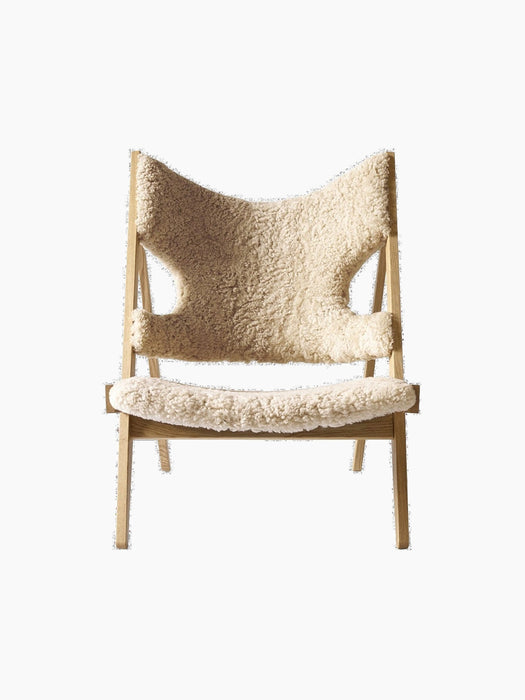 Front view of the Knitting Lounge Chair. The chair has a natural oak frame and off-white, textured sheepskin upholstery.