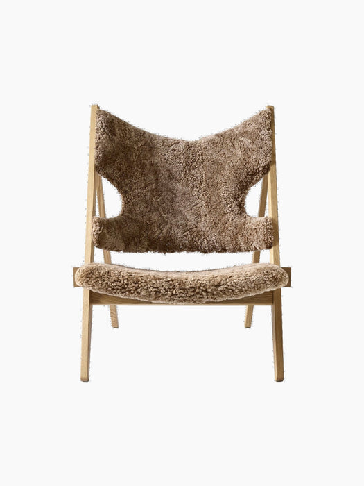 Front view of the Knitting Lounge Chair with a natural oak frame, upholstered in textured, light brown Sahara sheepskin.