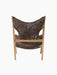 Back view of the Knitting Lounge Chair in dark brown Sheepskin Root, showing distinct elbow cut-outs and natural oak frame.