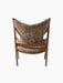 Back view of the Knitting Lounge Chair with a walnut frame and light brown sheepskin upholstery against a black background.