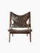 Front view of the Audo CPH Knitting Lounge Chair, featuring plush, dark brown 'Root' sheepskin upholstery on a walnut frame.