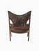 The back of the Knitting Lounge Chair, with a walnut wood frame and dark brown Root sheepskin upholstery with cut-outs.
