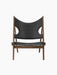 Knitting Lounge Chair shown from the front, with a walnut frame and black leather featuring signature cut-outs.