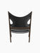 Back view of the Knitting Lounge Chair, showing its dark walnut frame and black leather seat with distinctive side cutouts.
