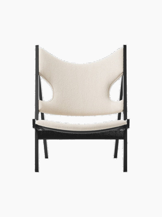 Front view of the Knitting Lounge Chair in Black Oak, featuring a textured ivory bouclé seat and backrest with side cut-outs.