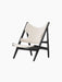 Angled view of the Knitting Lounge Chair in Black Oak, featuring an ivory bouclé seat and backrest on a black oak frame.
