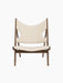 A front view of the Knitting Lounge Chair, with a dark wood frame and off-white textile seat and back with elbow cut-outs.