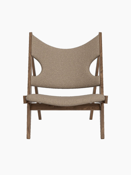 Front view of the Knitting Lounge Chair in walnut with light brown Logan Flint upholstery and its distinctive side cut-outs.