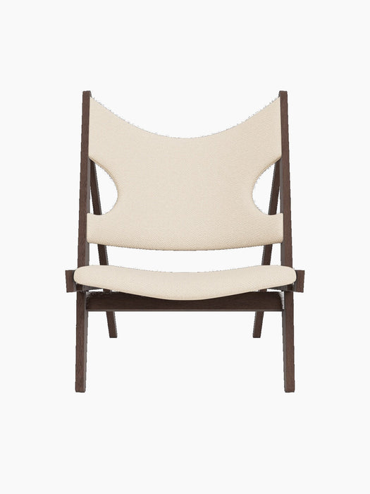 Front view of the Knitting Lounge Chair, with a dark stained oak frame upholstered in a light jasmine textile.