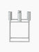 Front view of the Kubus 4 candle holder, with its square frame and four cylindrical sockets in a textured zinc finish.