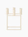 A front view of the ivory Kubus 4 candle holder, a square metal frame with four cylindrical holders for taper candles.