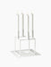 White Kubus 4 candelabra with four lit white candles, shown on the matching white Kubus Base against a black background.