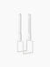 An angled view of the white Kubus Line candlestick, a minimalist design with a geometric frame, holding two white candles.