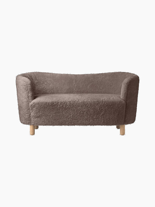 Front view of the Mingle Sofa upholstered in textured, Sahara-coloured sheepskin, with four light-coloured natural oak legs.