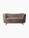 Front view of the Mingle Sofa upholstered in textured, Sahara-coloured sheepskin, with four light-coloured natural oak legs.