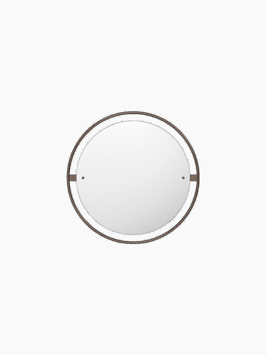 A front view of the Nimbus Mirror 60. The circular mirror features a delicate, bronzed brass frame and a matching outer halo.