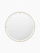 A front view of the large, circular Nimbus Mirror 110. It features a distinctive halo-like frame crafted from polished brass.