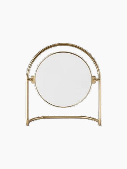 The Nimbus Table Mirror with a polished brass finish, shown from a front-angle view against a black background.