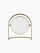 The Nimbus Table Mirror with a polished brass finish, shown from a front-angle view against a black background.