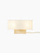 Front view of the wide Nonna Table Lamp in Travertine, featuring an illuminated rectangular sand-coloured shade on a base.