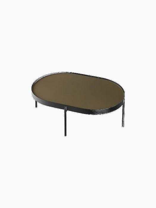 The large NoNo Table, an oval coffee table with a brown glass top and a slender black steel frame on a black background.