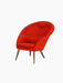 A three-quarter view of the Oda Lounge Chair, upholstered in a vibrant red Hallingdal 600 fabric with tapered walnut legs.