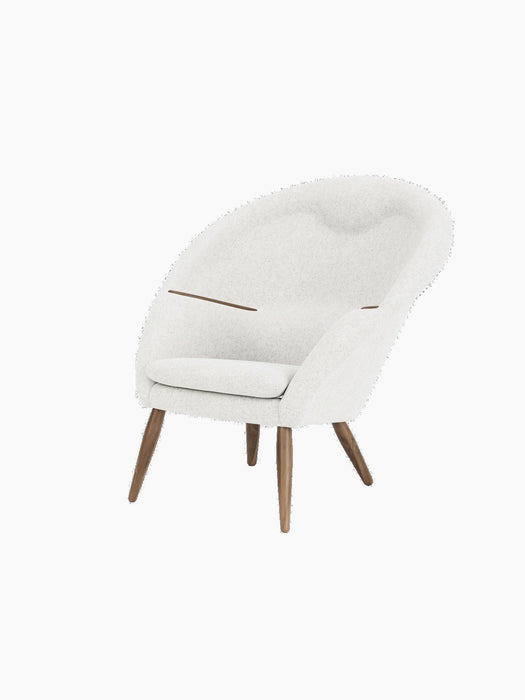 Three-quarter view of the Oda Lounge Chair with off-white Hallingdal 110 upholstery, walnut frame, and integrated armrests.